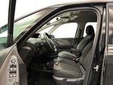 the interior of a car with the door open and the driver ' s seat down