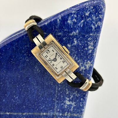 an image of a wrist watch on a blue stone