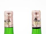 two bottles of wine sitting next to each other on a table