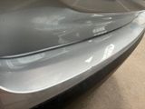 a close up of a car ' s tail end with a sticker on it