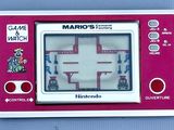 a red and white game console with a mario ' s watch on it