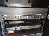 many electronics stacked on top of each other on a shelf