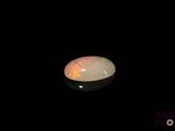 a picture of a white oplite in the dark
