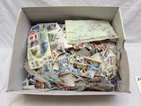 a box full of stamps and postcards sitting on a table