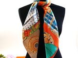 an orange and blue scarf on a mannequin neck