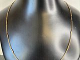 a close up of a mannequin with a necklace on it