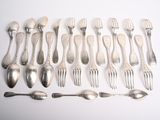 a lot of forks and spoons on the table