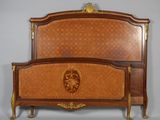 a bed with a wooden headboard and foot board on it