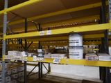 a yellow shelf in the middle of a warehouse filled with boxes