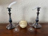three wine glasses and a candle holder on a table
