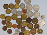 a pile of coins on a table with a white background