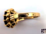 an image of a gold ring with a black diamond