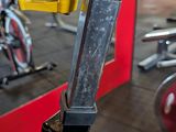 a bike that is sitting in a gym with other bikes