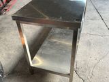 a stainless steel table with a shelf on the top