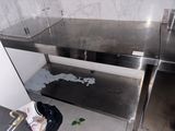a dirty sink in the corner of a kitchen