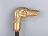 a golden cane with a dog head on top of it