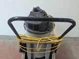 a machine that is sitting on the floor with a yellow cord
