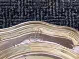 a silver plate that is sitting on a black carpet