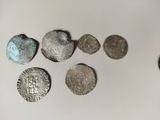 some silver coins are sitting on a white surface next to a coin