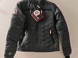 the jacket is hanging on the wall with a tag attached to it