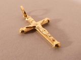 a gold cross that is laying on a table