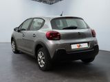 the rear of a silver car parked inside of a building