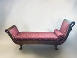 a bench with a pink upholstered cushion on it