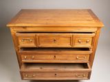 a wooden dresser with three drawers and a drawer underneath it