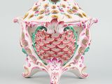 a white and pink vase with a bird on it