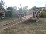 une charrette en bois qui est posée dans l'herbe