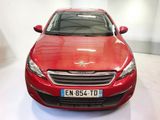 the red car is parked in the white room of the showroom
