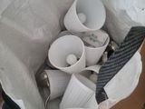 a bag full of cups and spoons sitting on a table