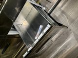 a stainless steel refrigerator in the middle of a kitchen