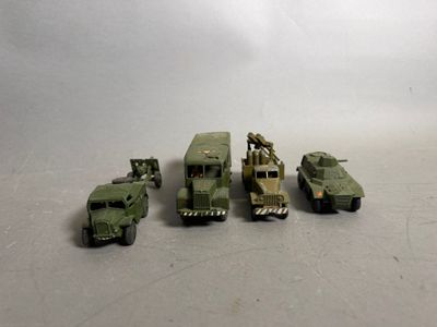 several toy army vehicles are lined up in a row on a table