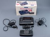 a game system that is sitting on a table next to a box