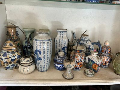 many vases on a shelf in a room