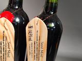 two bottles of wine that are sitting on a table