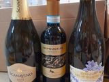 several bottles of wine are lined up on a counter top