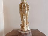 a statue of a man and a woman on a wooden table