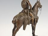 bronze statue of a man on a horse with a shield on his head