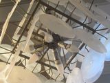 many plates that are hanging from the ceiling in the room