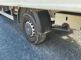 a flat tire on a flatbed truck parked on the side of the road