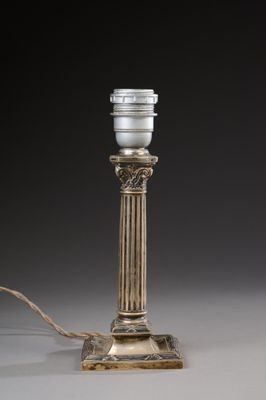 an antique silver plated table lamp with a white glass shade
