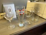 bottles and glasses on a table with a toaster and toaster