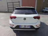 the rear end of a white volkswagen suv parked in a parking lot