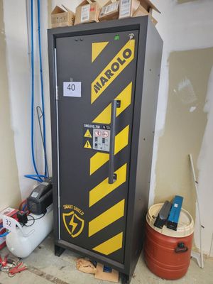a black and yellow locker with a sign on it
