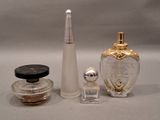 three bottles of perfume sitting next to each other on a table