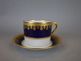 a close up of a cup and saucer on a table
