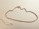 a gold necklace with a chain that is attached to it