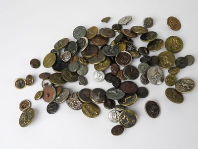 a pile of coins sitting on a white surface